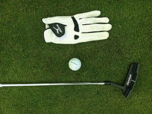 golf trip checklist featured image of golf gloves a club and a ball jubilee course