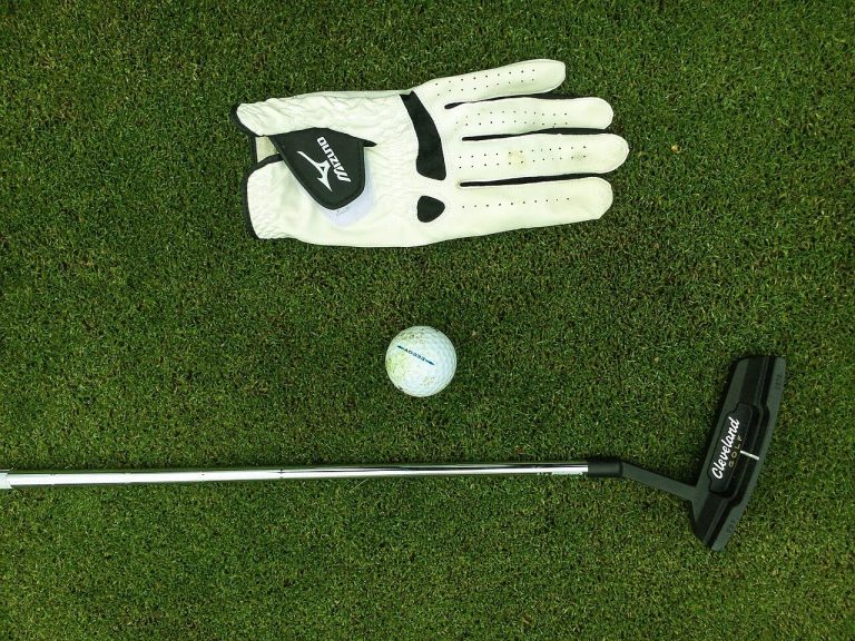 golf trip checklist featured image of golf gloves a club and a ball jubilee course